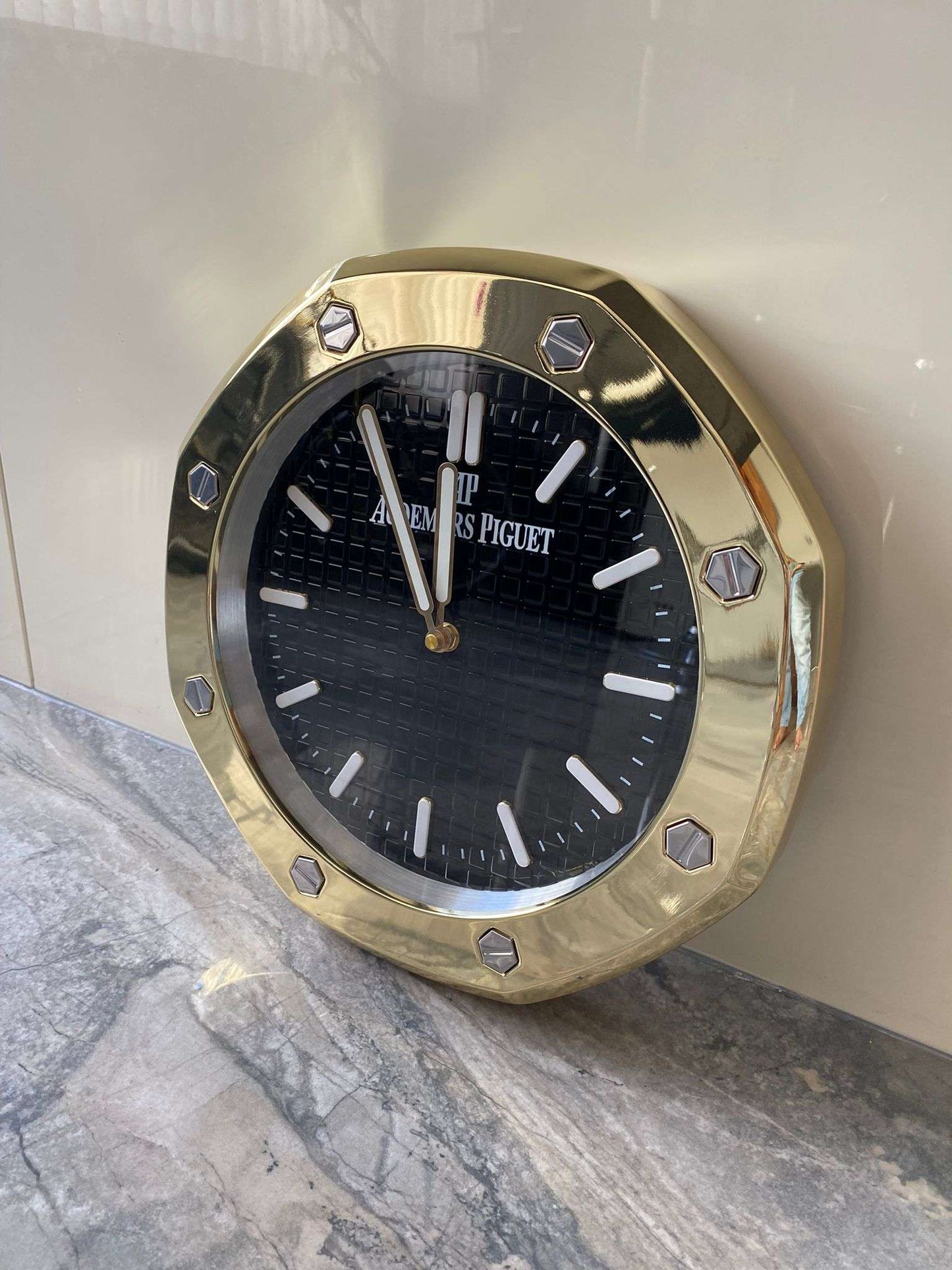 Luxurious stainless steel wall clock based on yellow gold bezel and black face