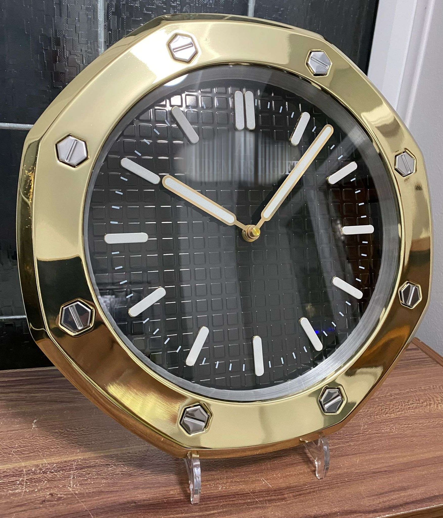 Luxurious stainless steel wall clock based on yellow gold bezel and black face